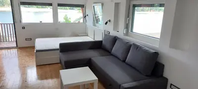 a living room with a couch and a bed at Island Ada in Čukarica