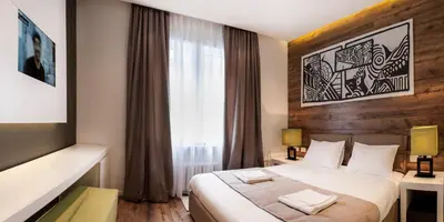a hotel room with a bed and a window at Eden Garden Suites in Belgrade