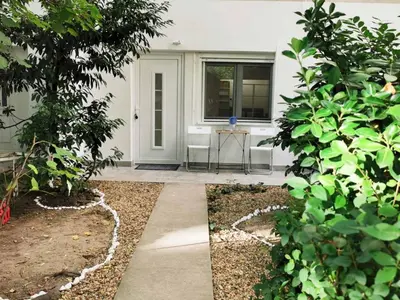 a front porch of a house with a table and trees at Tesla in Belgrade