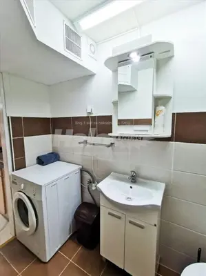 a bathroom with a sink and a washing machine at Tesla in Belgrade