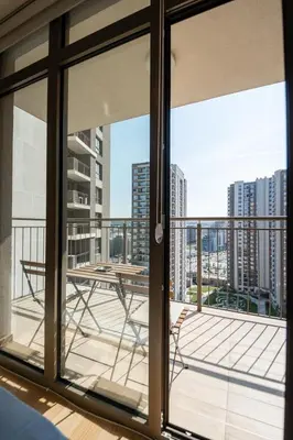 a balcony with a table and a view of the city at Belgrade Waterfront Nimax in Sajmište