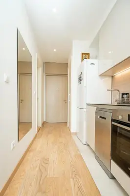 a kitchen with white appliances and a wooden floor at Belgrade Waterfront Nimax in Sajmište