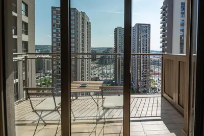 a balcony with two chairs and a table on a balcony at Belgrade Waterfront Nimax in Sajmište