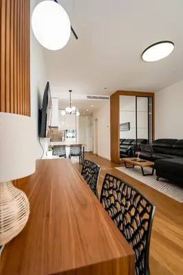 a dining room and living room with a table and chairs at West 21 Tower in Fontana