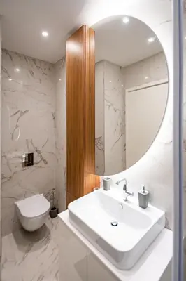a white bathroom with a sink and a mirror at West 21 Tower in Fontana