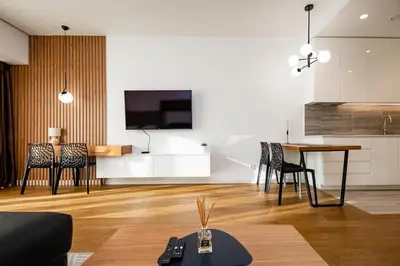 a living room with a kitchen and a table and chairs at West 21 Tower in Fontana