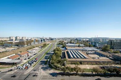 an aerial view of a city with a parking lot at West Tower Luxury in Fontana