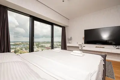 a bedroom with a large white bed with a large window at West Tower Luxury in Fontana