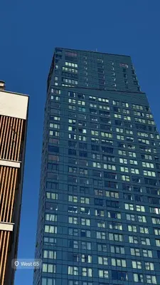 a tall glass building with many windows at West Tower Luxury in Fontana