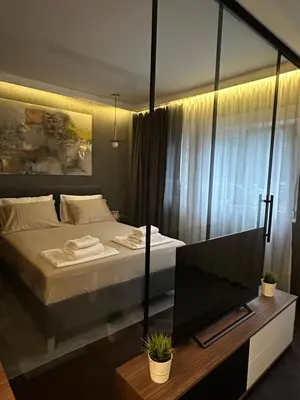 a bedroom with a bed and a tv on a table at Sima City Center in Belgrade