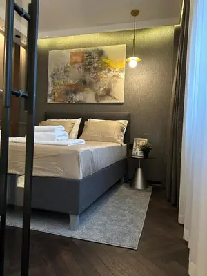 a bedroom with a bed and a painting on the wall at Sima City Center in Belgrade
