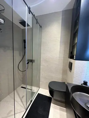 a bathroom with a shower and a toilet and a sink at Sima City Center in Belgrade
