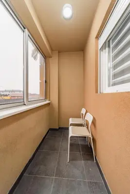 a room with two chairs and two windows at Port 1 in Belgrade