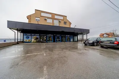 a building with cars parked in a parking lot at Port 1 in Belgrade
