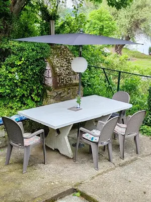 a picnic table with two chairs and an umbrella at Varljivo leto, Fruska gora in Čortanovci