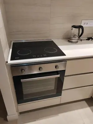 a stove top oven in a small kitchen at Apartman Julija in Sajmište