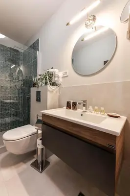 a bathroom with a sink and a toilet and a mirror at Villa 1927 in Belgrade