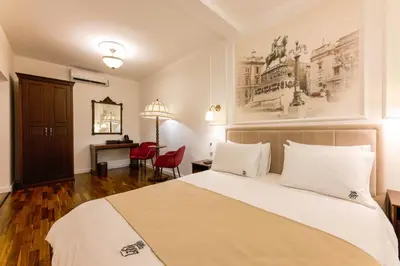 a hotel room with a bed and a desk at Villa 1927 in Belgrade