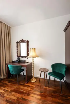 a room with a desk and two chairs and a mirror at Villa 1927 in Belgrade