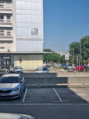 a car parked in a parking lot next to a building at Euforia apartment in Novi Beograd