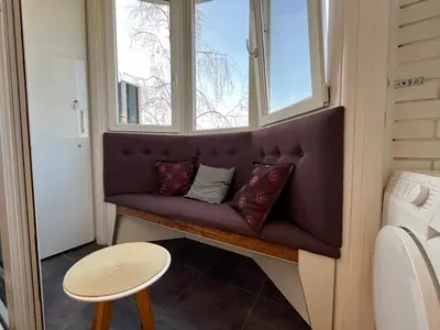 a bench in a window with pillows on it at Hedonic Studio in Belgrade