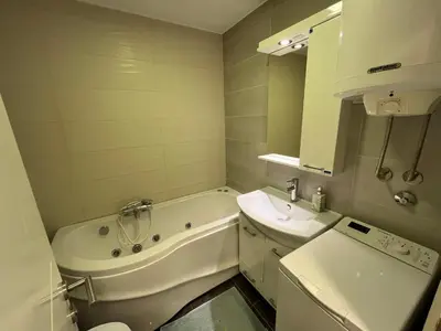 a bathroom with a tub and a sink and a toilet at Hedonic Studio in Belgrade