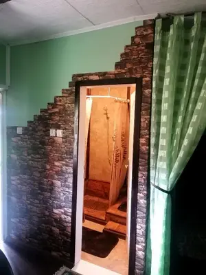 a room with a brick wall and a doorway at Sunny Side Fruska Gora- apartman A in Velika Remeta