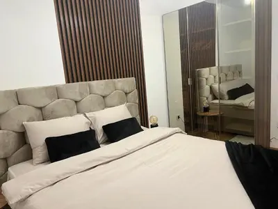 a bedroom with a large white bed with two pillows at Luxe Living Modern Apartment Stara Pazova in Stara Pazova