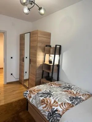 a bedroom with a bed and a dresser and a mirror at Luxe Living Modern Apartment Stara Pazova in Stara Pazova