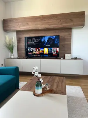 a living room with a blue couch and a tv at Luxe Living Modern Apartment Stara Pazova in Stara Pazova