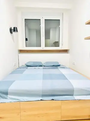 a bed in a bedroom with a window at Angelo S in Belgrade
