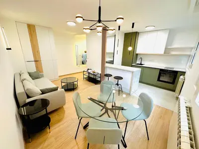 a living room with a glass table and chairs at Angelo S in Belgrade