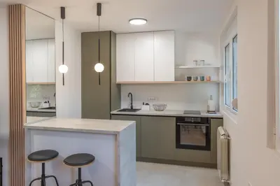 a kitchen with a counter and stools in it at Angelo S in Belgrade