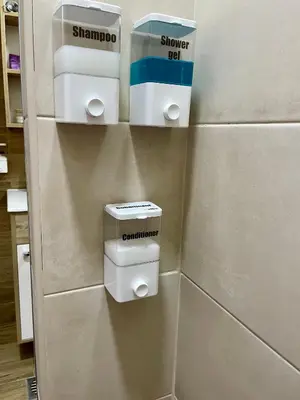 a bathroom with two toilet paper dispensers on a wall at Airport Apartments Alexandra in Surčin