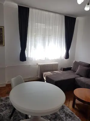 a living room with a white table and a couch at Emili apartment in Belgrade