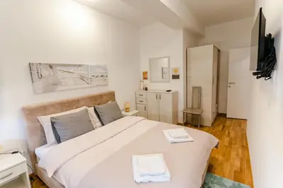 a bedroom with a large bed with two towels on it at Rajski Kutak in Arandjelovac