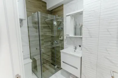 a bathroom with a glass shower and a sink at Rajski Kutak in Arandjelovac