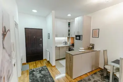 a kitchen with white cabinets and a counter top at Rajski Kutak in Arandjelovac