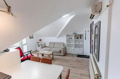 a living room with a couch and a table at RoofTop in Arandjelovac