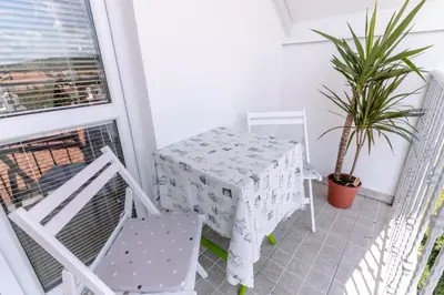 a balcony with a table and chairs on a balcony at RoofTop in Arandjelovac