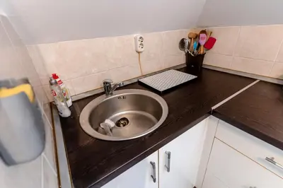 a kitchen counter with a sink in a room at RoofTop in Arandjelovac