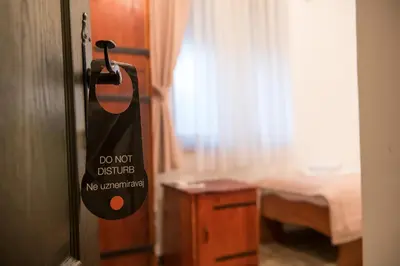 a room with a door with a do not disturb sign at Gardoš rooms in Zemun