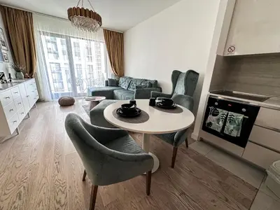 a living room with a table and chairs at Beldorado Apartments - Belgrade Waterfront Luxury Emerald Apartment 60m2 in Belgrade