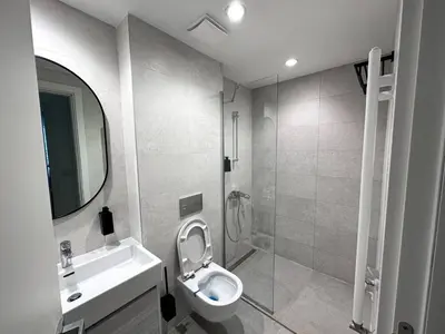a bathroom with a toilet and a sink and a shower at Beldorado Apartments - Belgrade Waterfront Luxury Emerald Apartment 60m2 in Belgrade