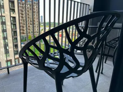 a black bench sitting on top of a balcony at Beldorado Apartments - Belgrade Waterfront Luxury Emerald Apartment 60m2 in Belgrade