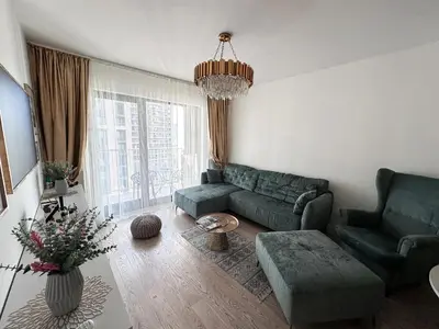 a living room with a couch and chairs and a chandelier at Beldorado Apartments - Belgrade Waterfront Luxury Emerald Apartment 60m2 in Belgrade