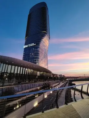 a tall building with a reflection of the sky at Beldorado Apartments - Belgrade Waterfront Luxury Emerald Apartment 60m2 in Belgrade