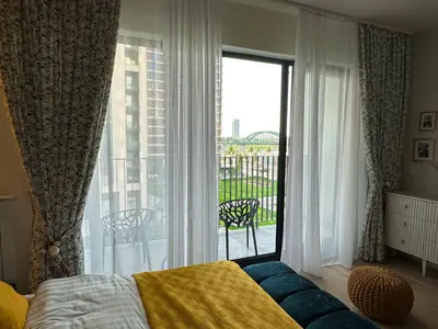 a bedroom with a bed and a large window at Beldorado Apartments - Belgrade Waterfront Royal Luxury Studio in Belgrade