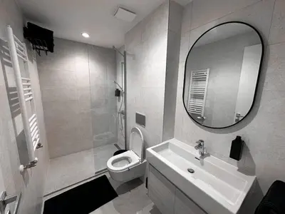 a bathroom with a sink and a toilet and a mirror at Beldorado Apartments - Belgrade Waterfront Royal Luxury Studio in Belgrade