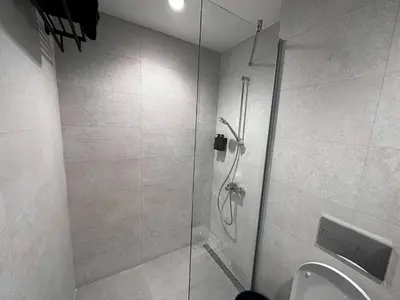 a bathroom with a shower and a toilet at Beldorado Apartments - Belgrade Waterfront Royal Luxury Studio in Belgrade